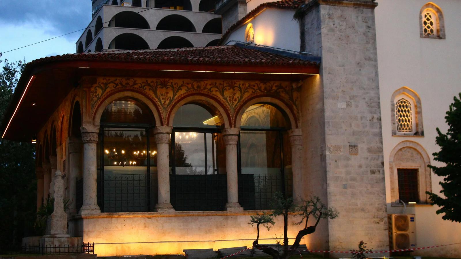 a tall building with a clock tower next to it