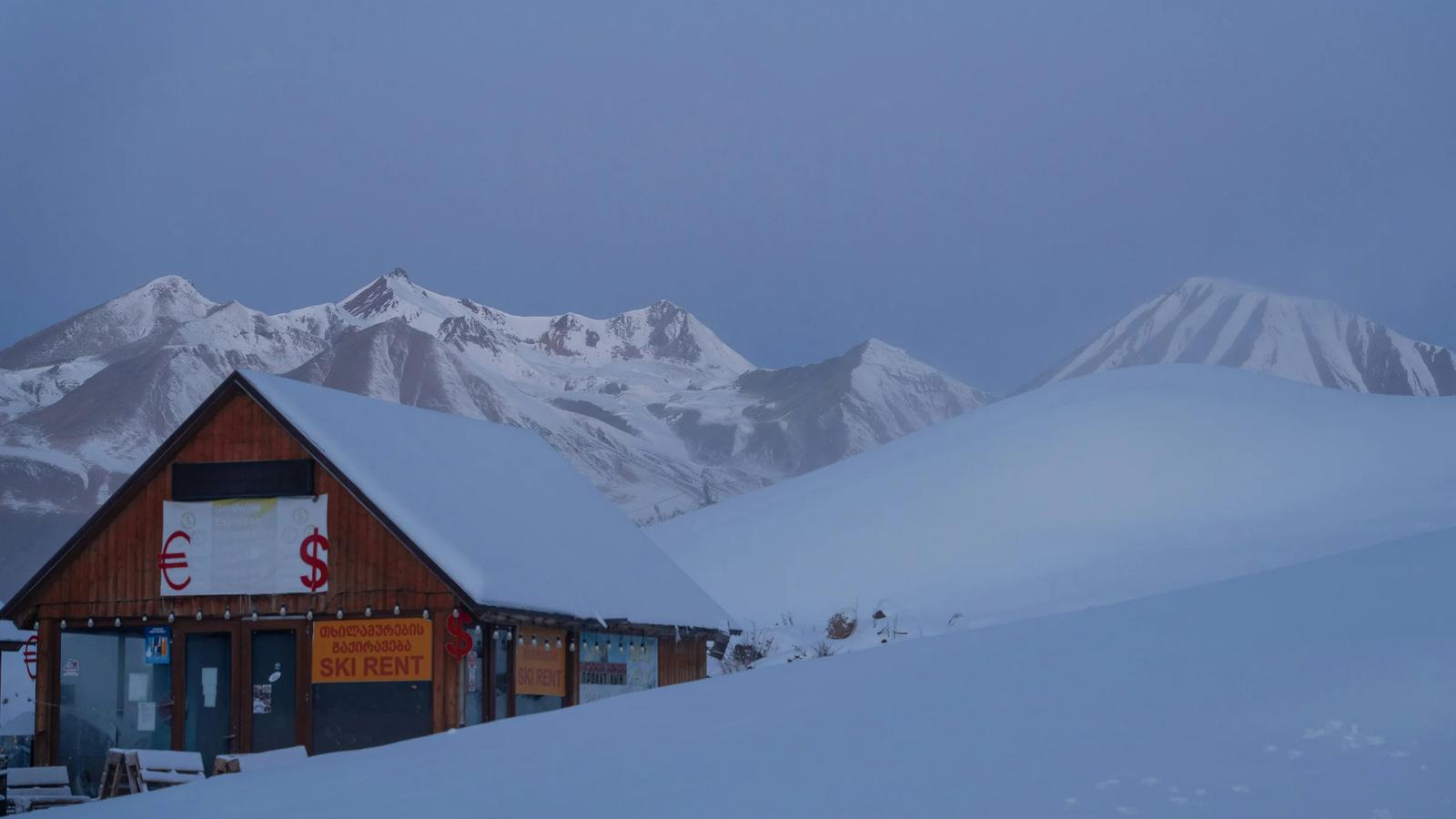 a building in the middle of a snowy mountain range