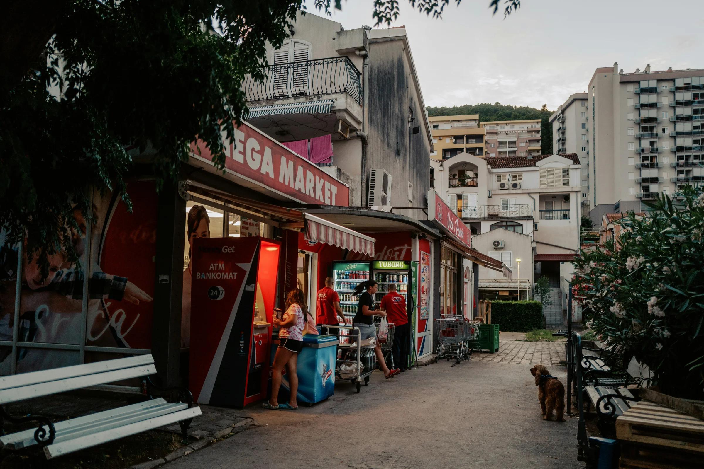 A street scene with a bench and a store
