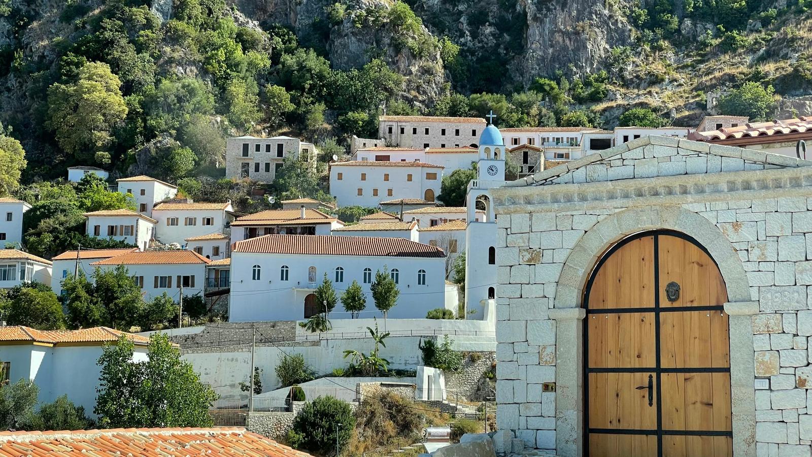 a small white building with a wooden door