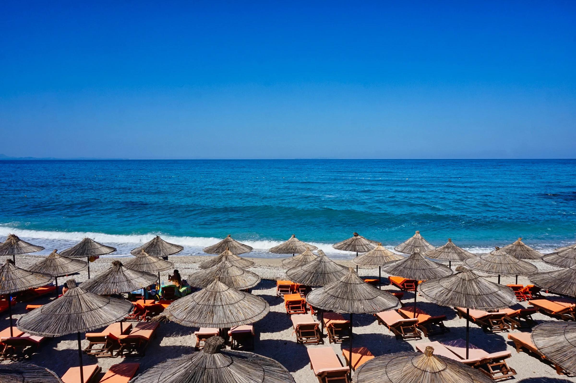 A bunch of umbrellas that are on a beach