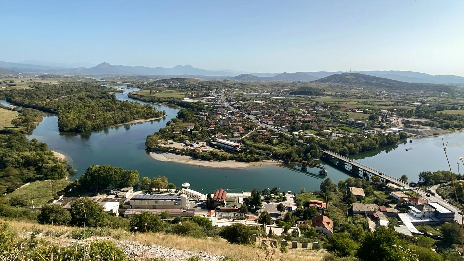 a river running through a lush green countryside