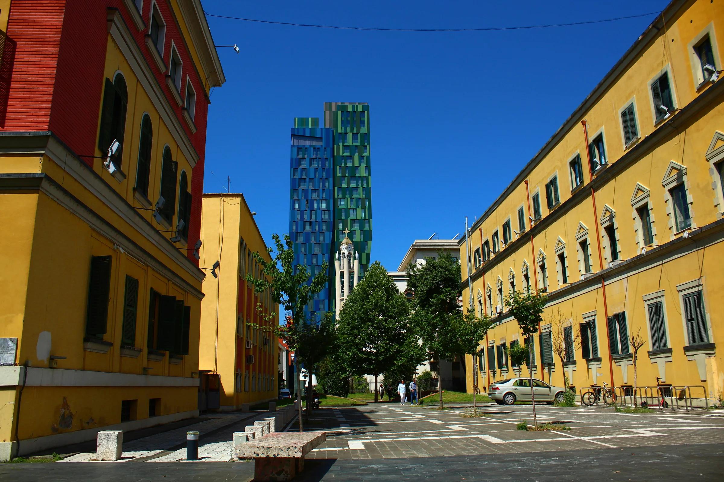a city street lined with tall buildings next to each other