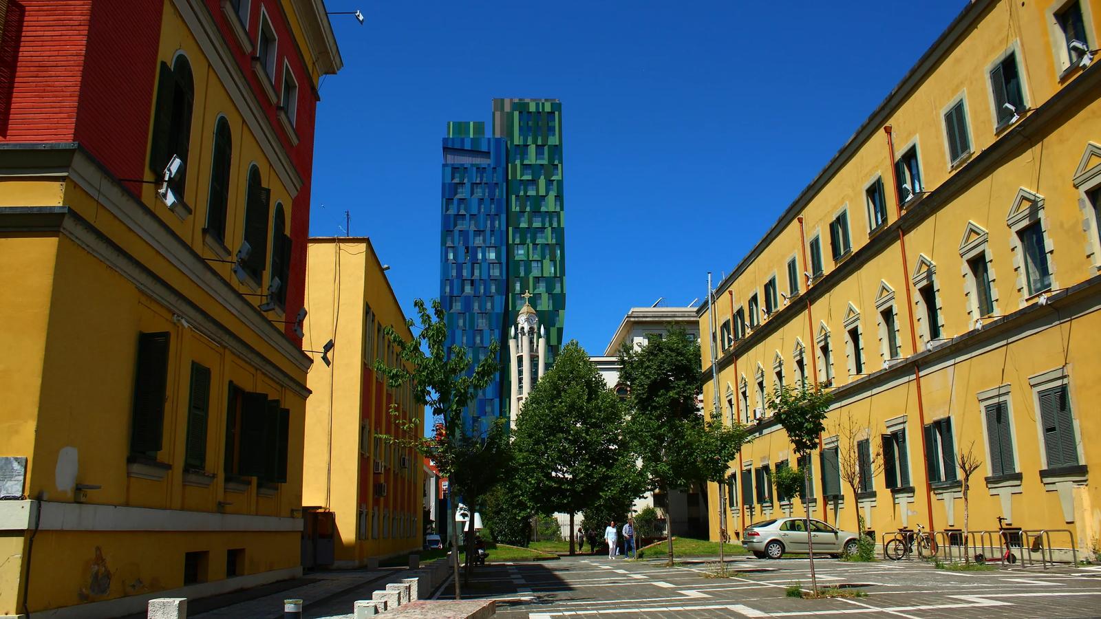 a city street lined with tall buildings next to each other