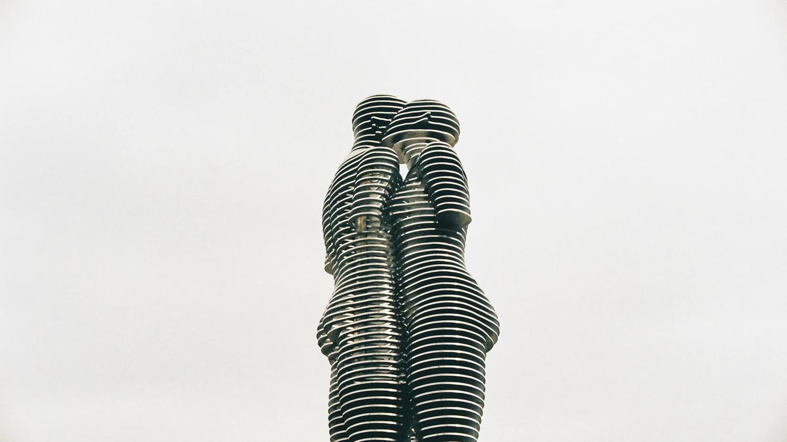 a statue of two people standing next to each other