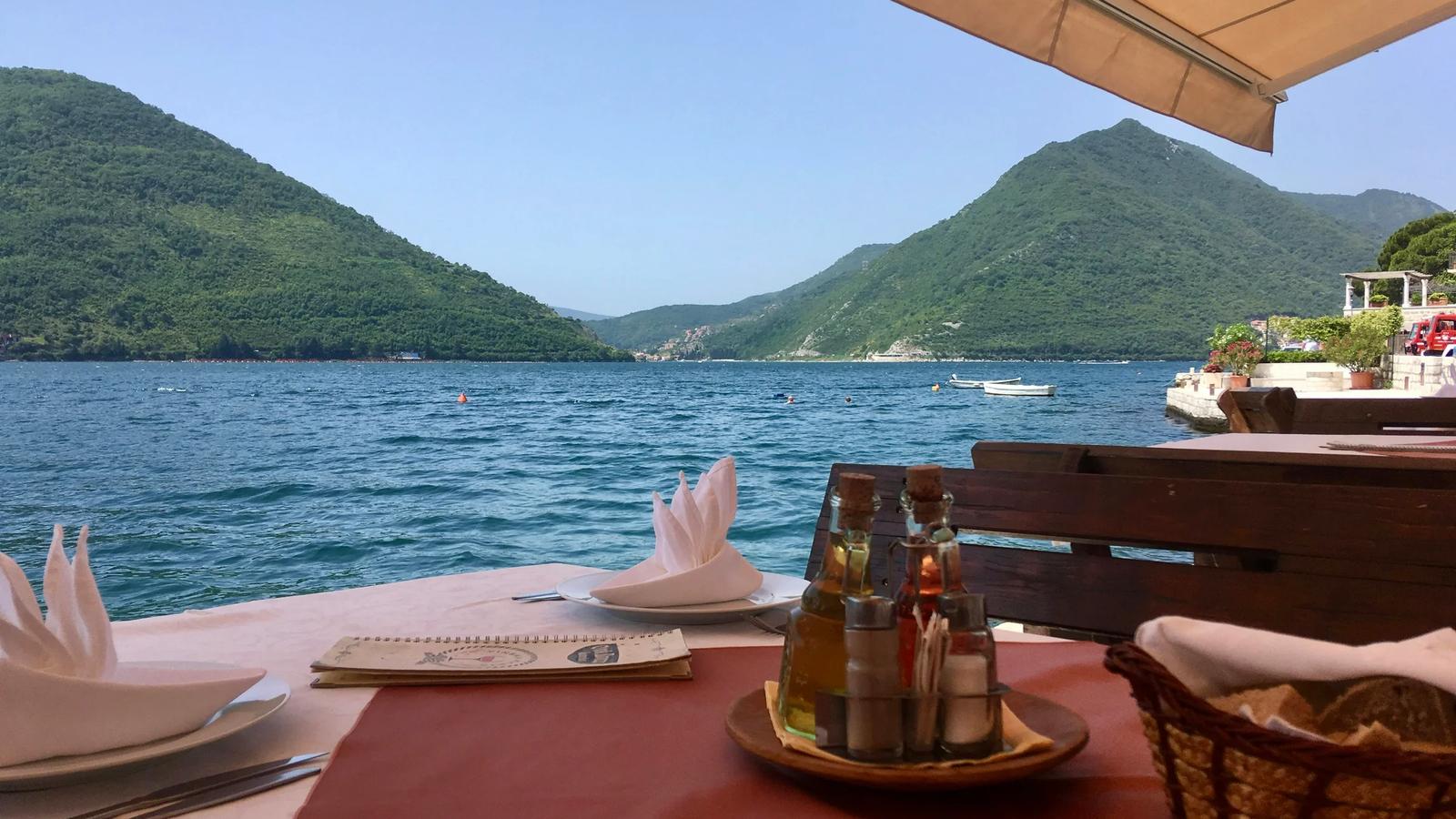 a table with a bottle of wine and a basket on it