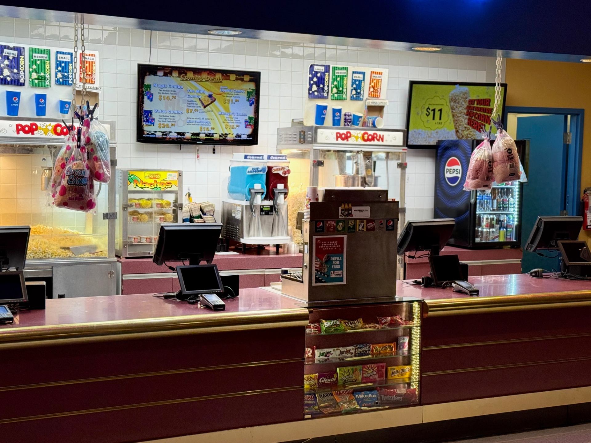 Concession stand with popcorn, drinks, and candy at Magic Lantern Duggan Cinema.