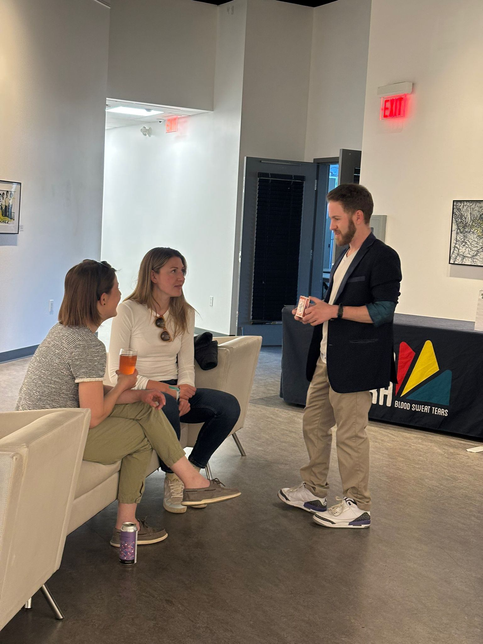 Attendees chat with a presenter in a gallery lounge during the festival.