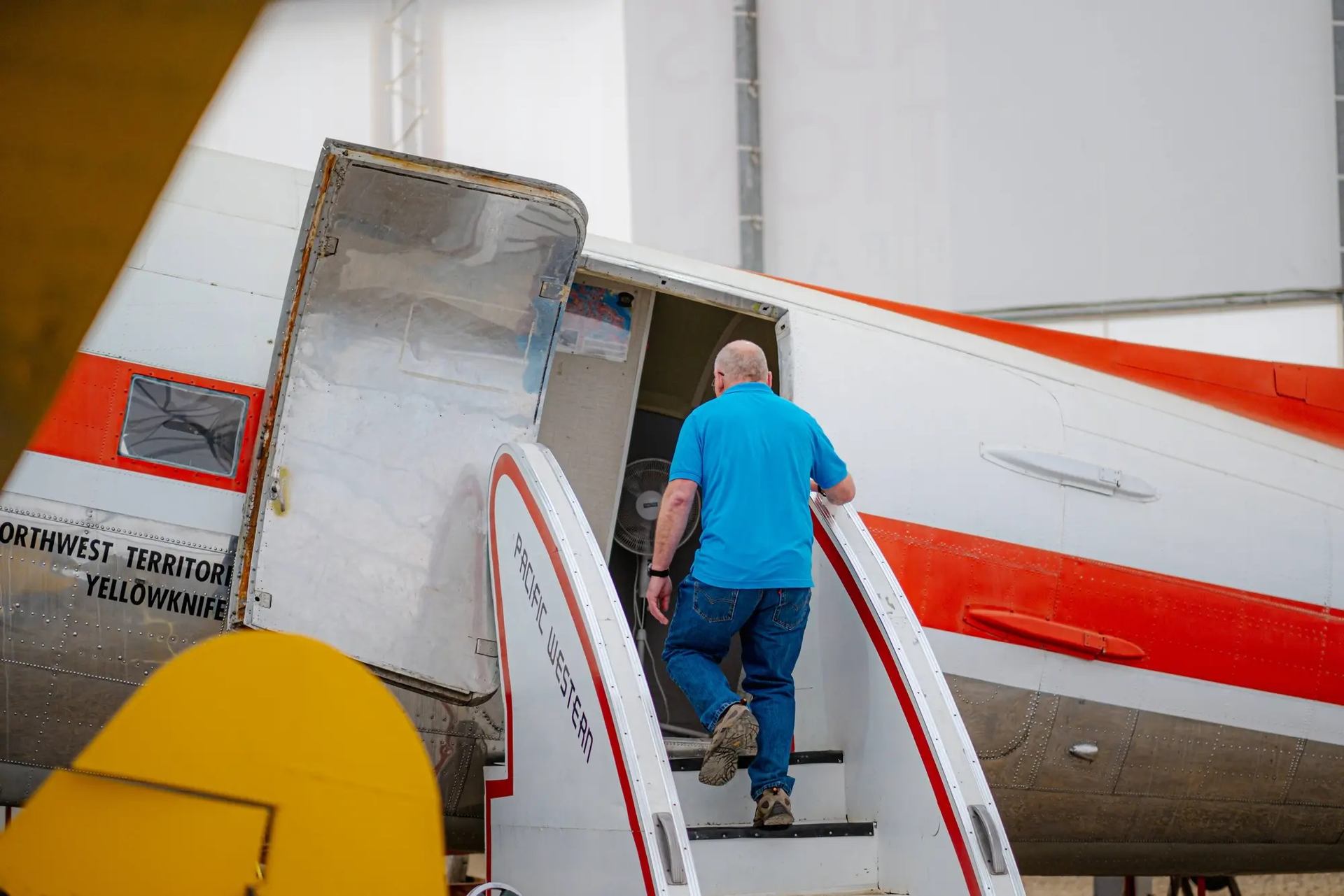 A father entering a plane.
