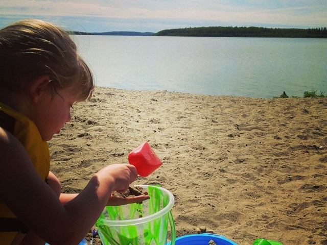 A child playing in the sand.