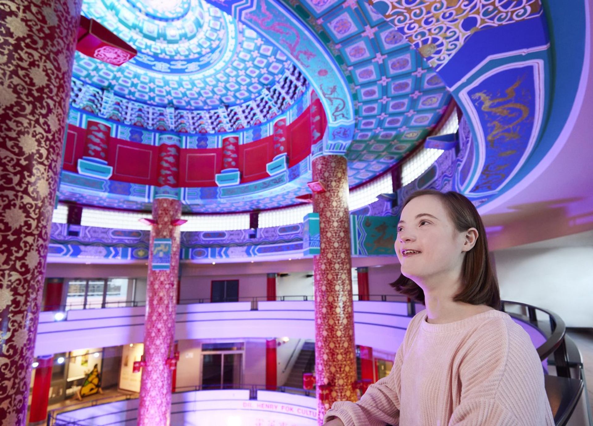 Intricate blue and red ceiling design with ornate pillars inside the Chinese Cultural Centre.