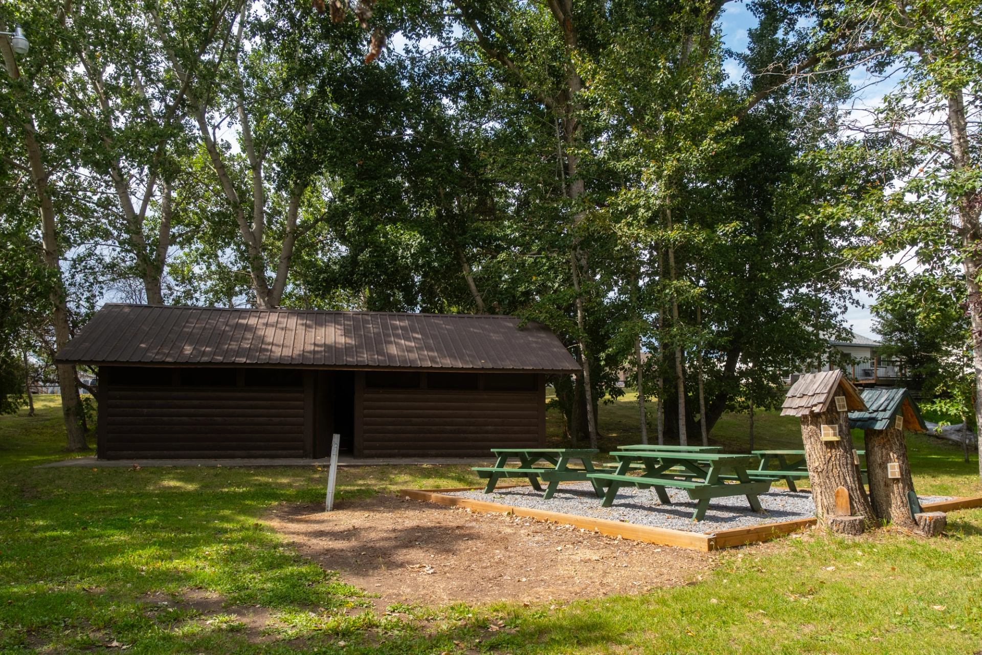 Facilities with picnic tables and trees all around.