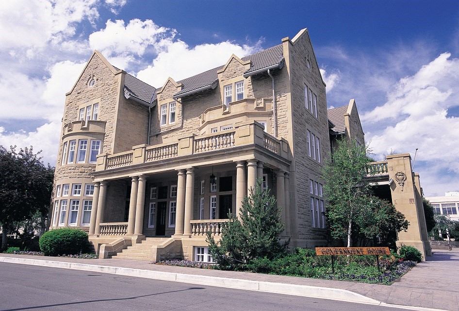 Stone mansion with columns and balcony at Government House Alberta in Edmonton, Alberta.
