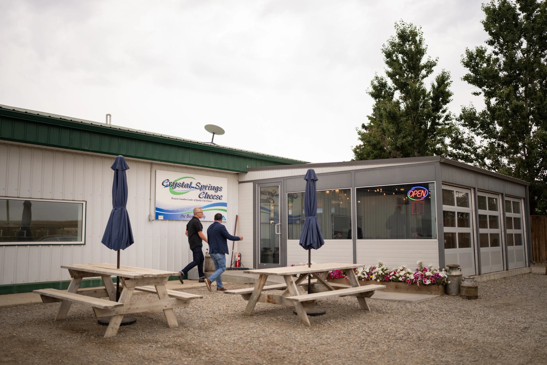 Two men walking into Crystal Springs Cheese.