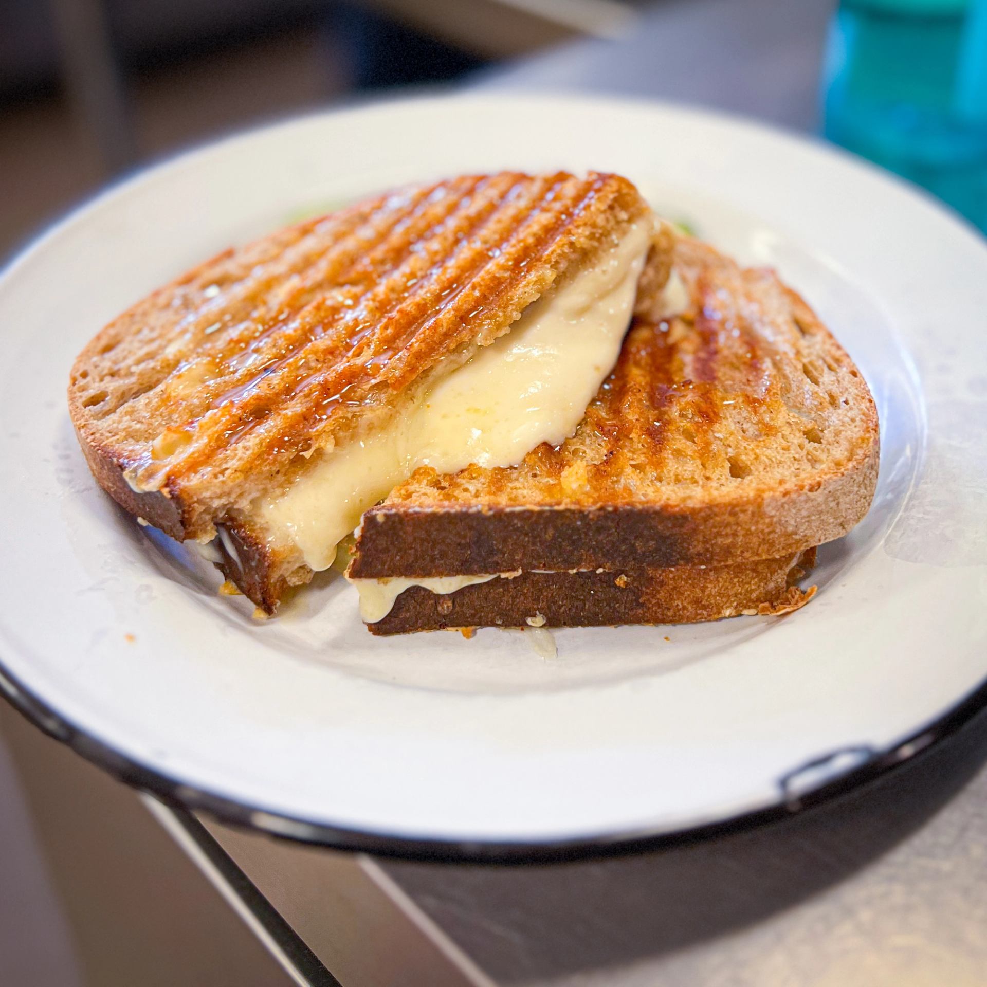 Grilled cheese sandwich with melted cheese on toasted bread.