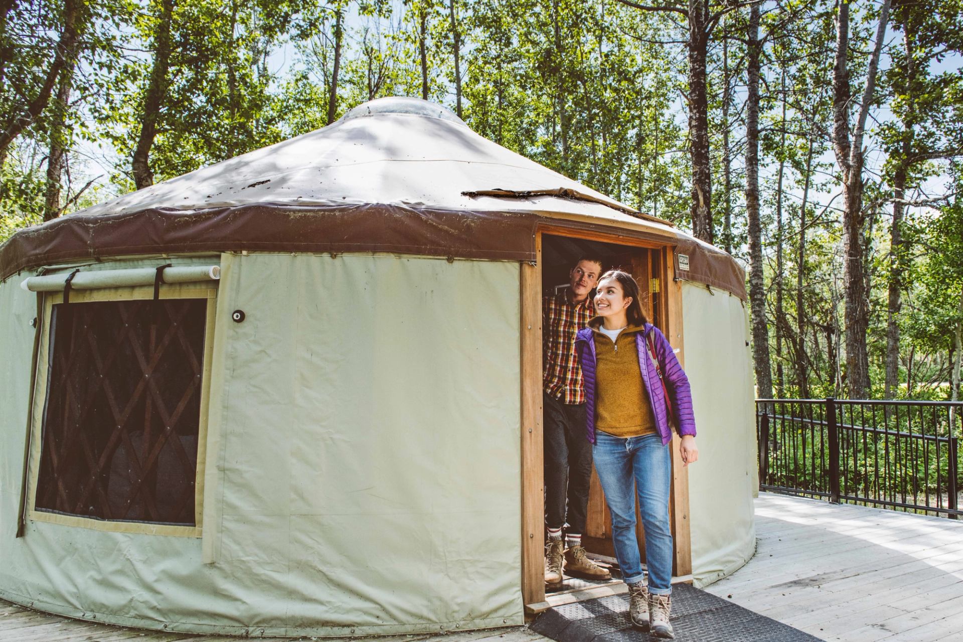 Couple leaving their Yurt at Pigeon Lake campground Comfort Camping.