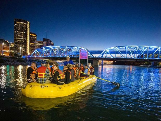 Tour group floating down the Bow River at dusk.