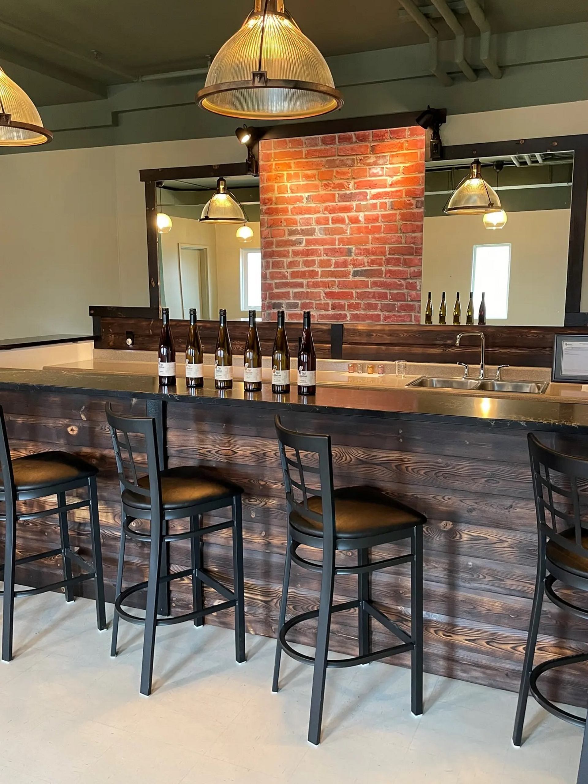 Tasting room with bar and stools. 