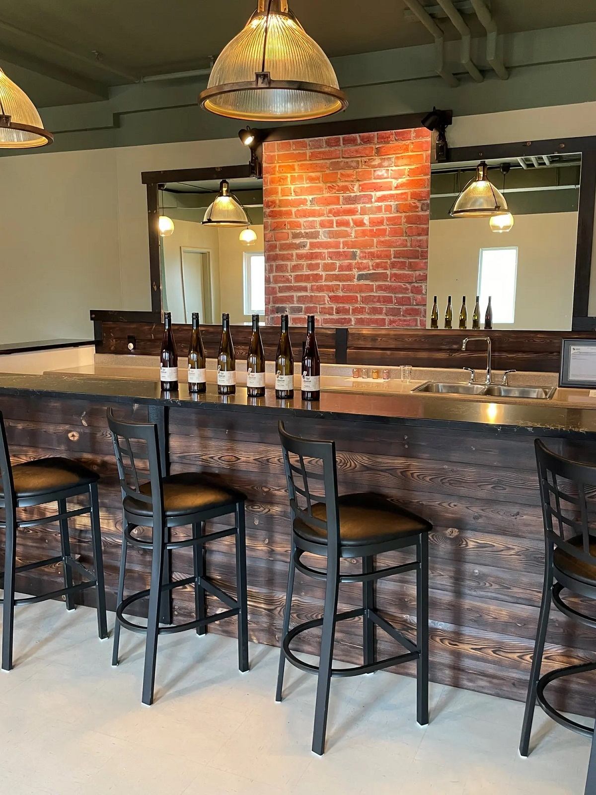 Tasting room with bar and stools.