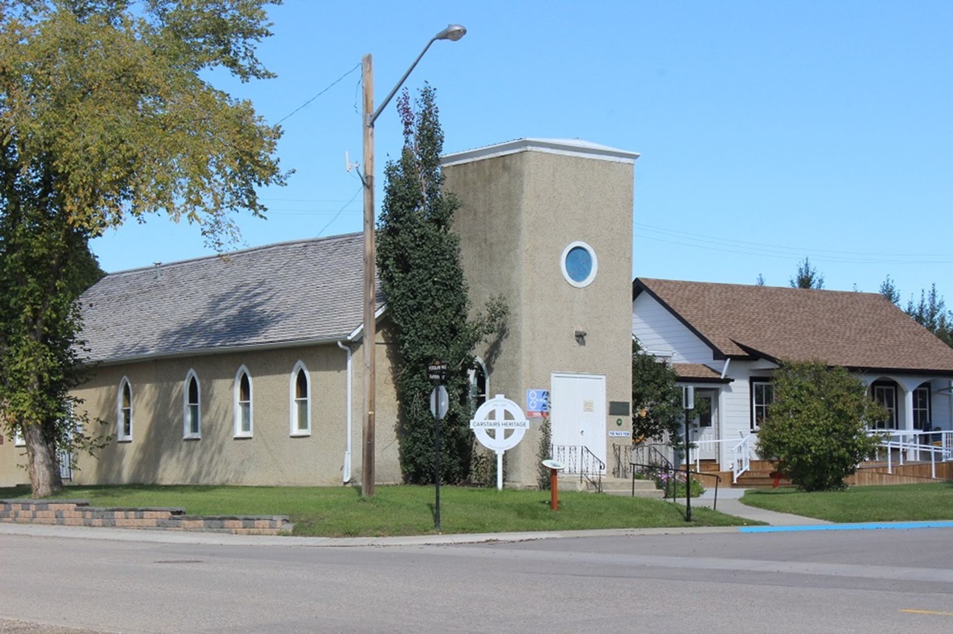 Carstairs Heritage Centre building with arched windows, trees and an accessible entrance.