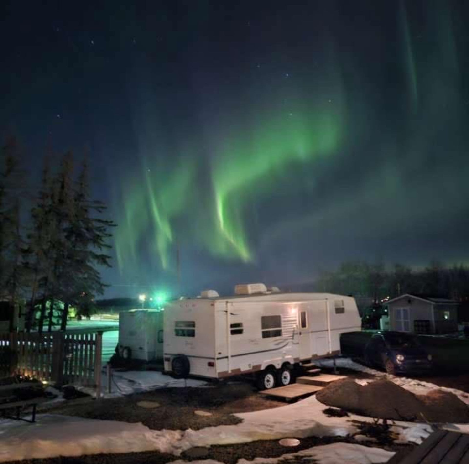 RV under northern lights at Lamont RV Park and Campground.