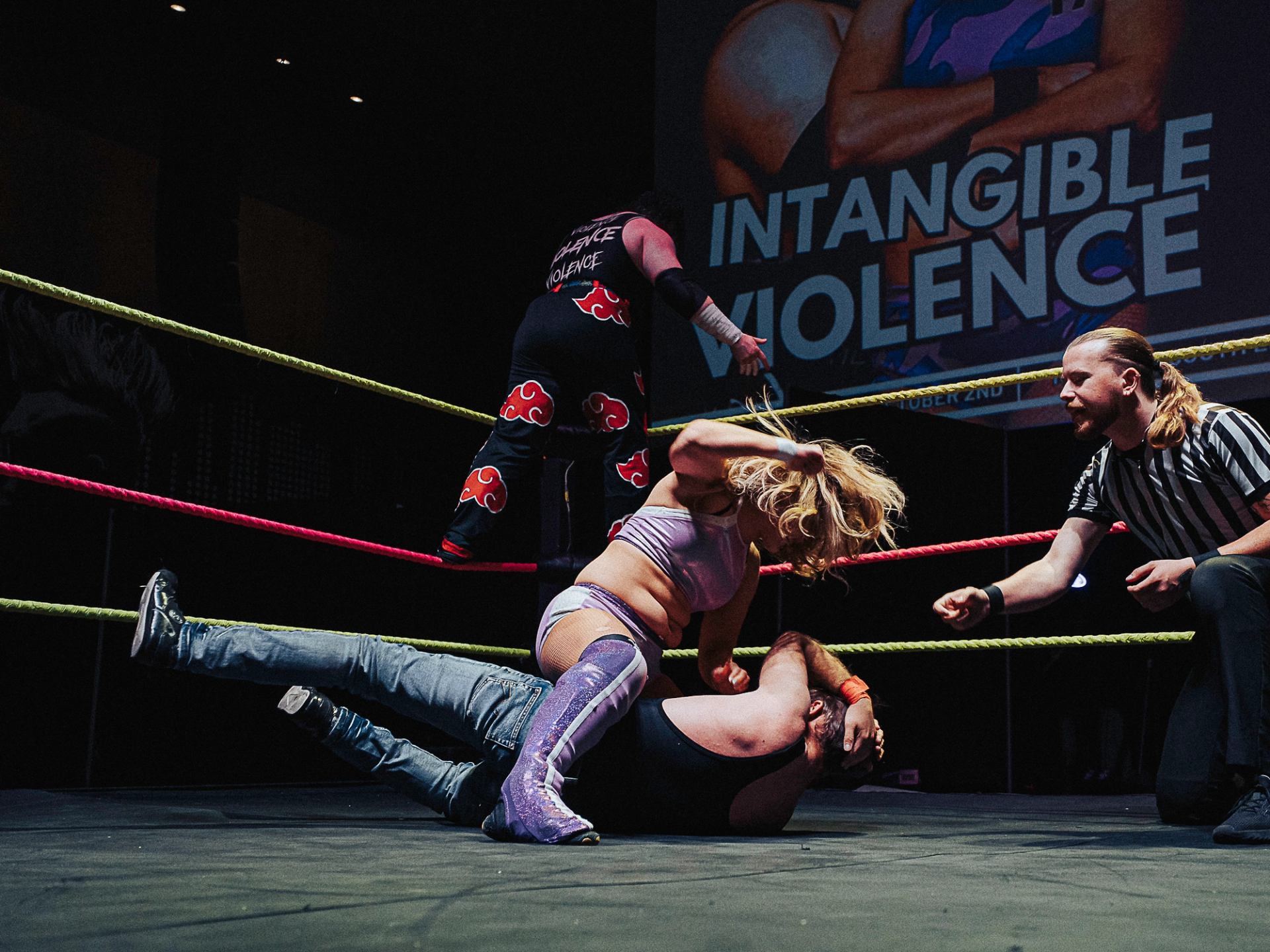 Wrestler pins opponent as referee counts in Love Pro Wrestling match.