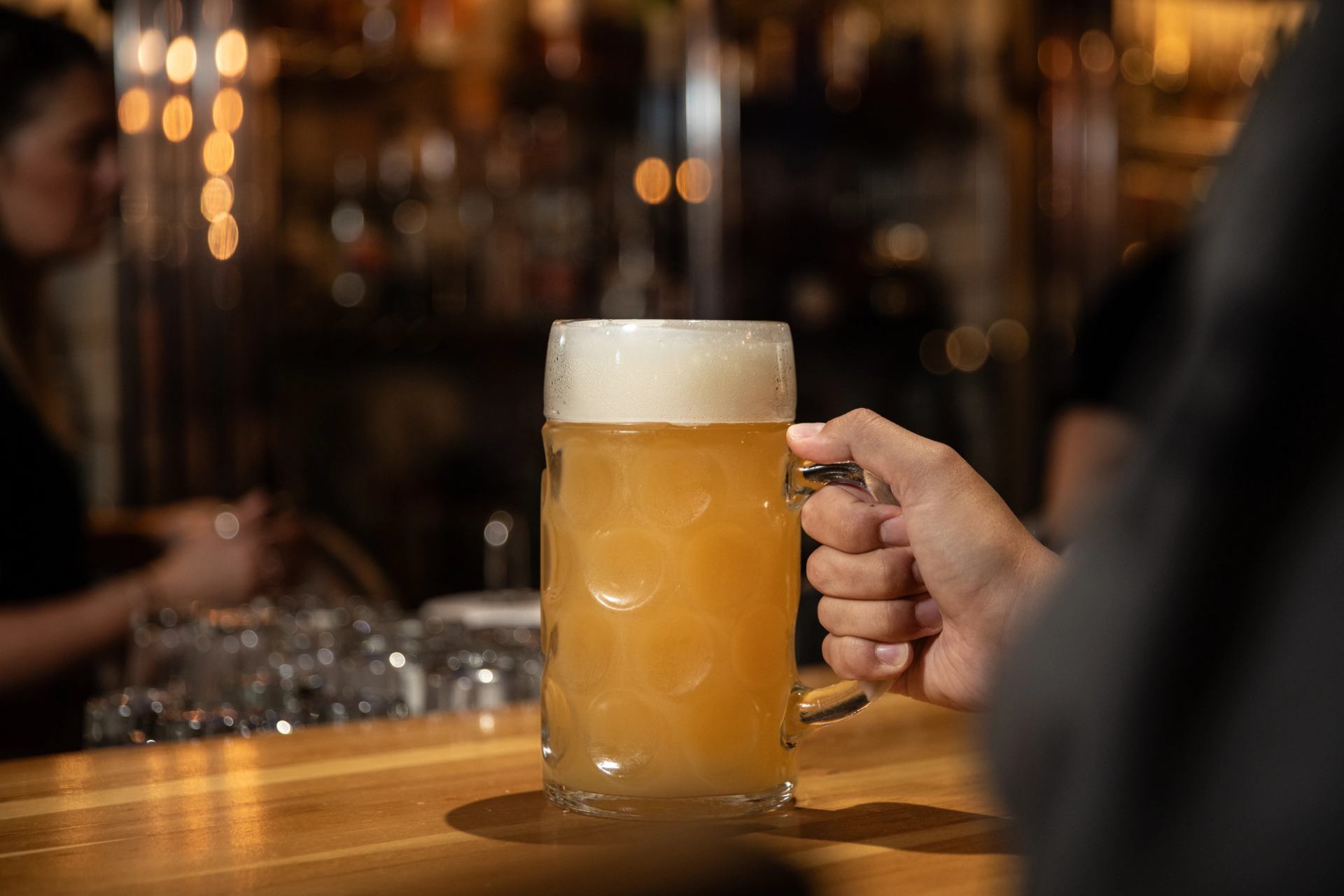 A stein of beer sits on the bar.