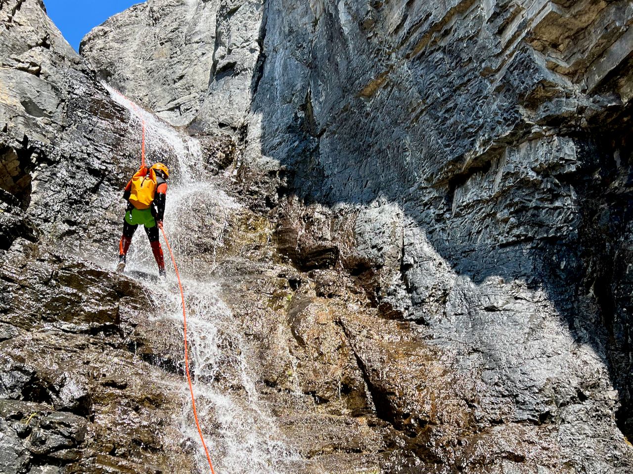 Person rappelling down a rocky waterfall in Bow Valley Canyon.