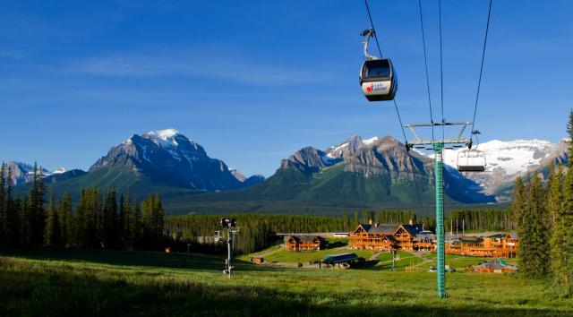 People riding the gondola at Lake Louise with Chalet in the background.