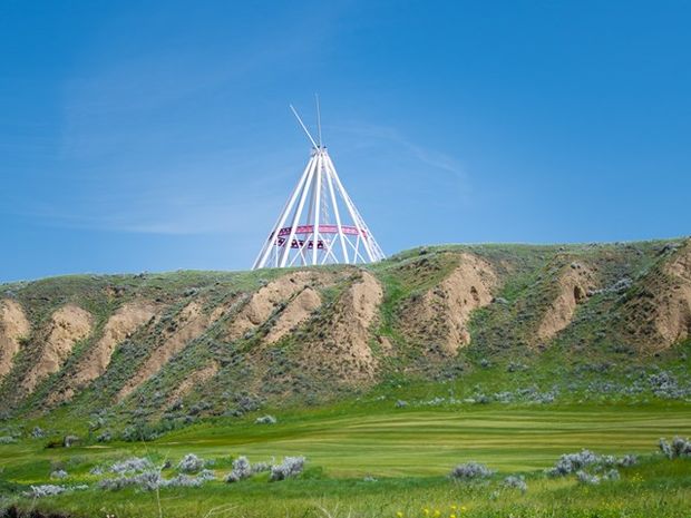 A wide shot of the tipi on top of the ridge.