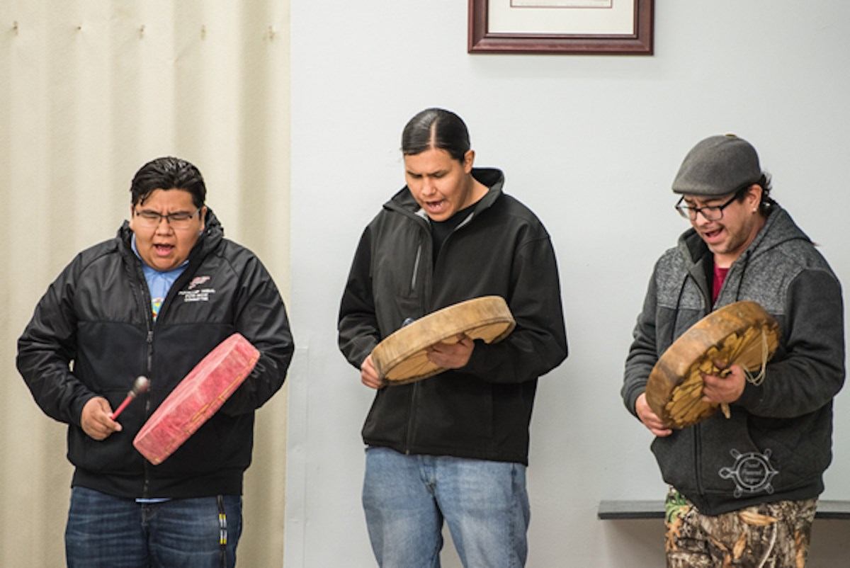 Three men drumming during Indigenous Veterans Day