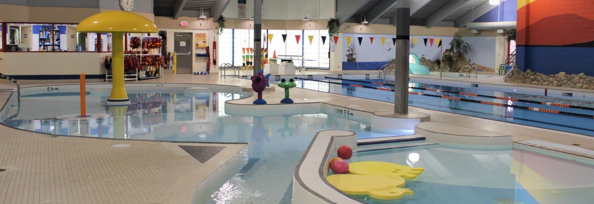 Indoor aquatic centre with shallow play pool, mushroom fountain and lane swimming pool.