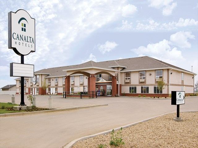 Exterior of Canalta Provost with brick facade, hotel sign, and covered guest entrance.