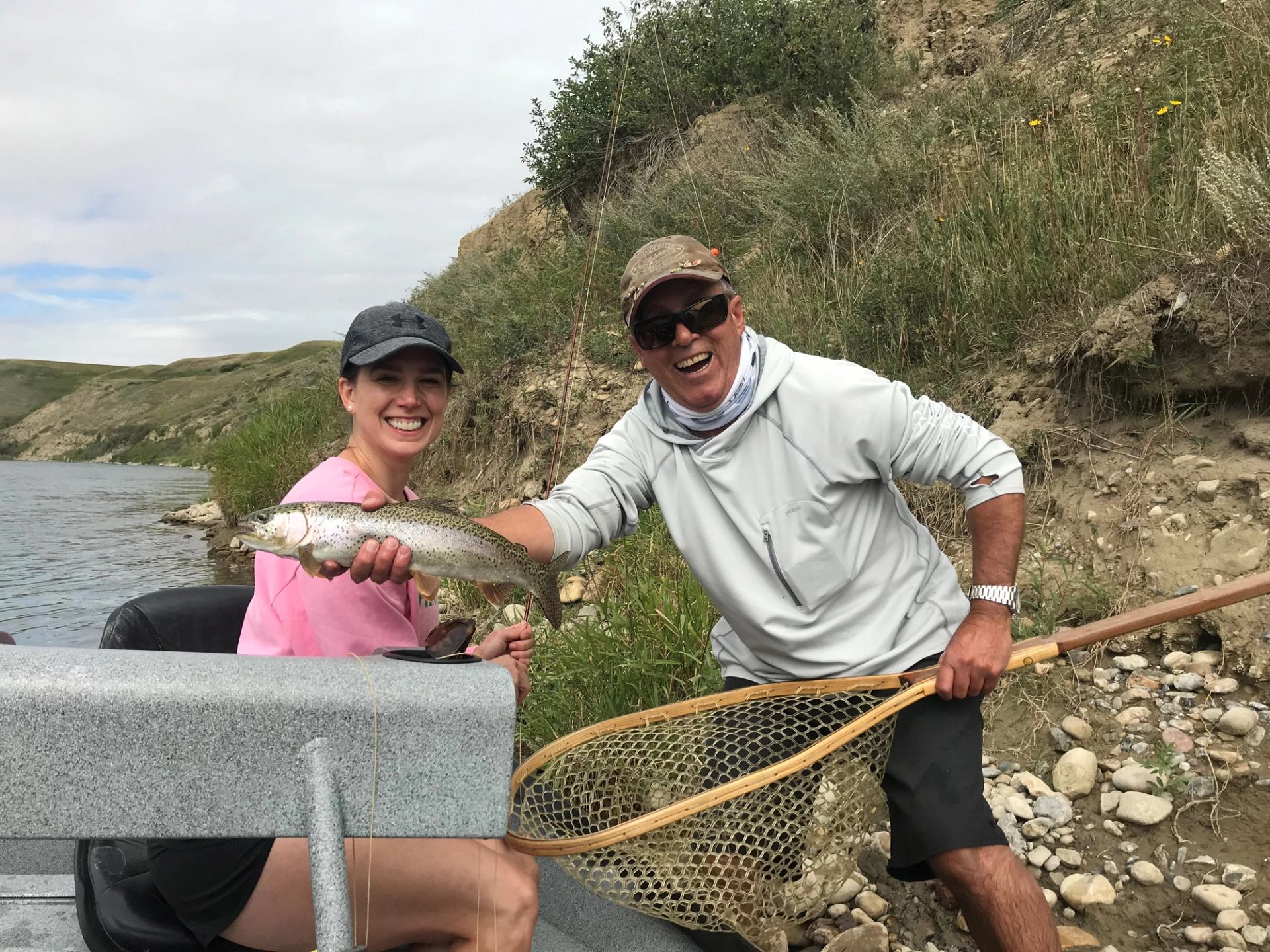 A man and a women showing their catch of the day