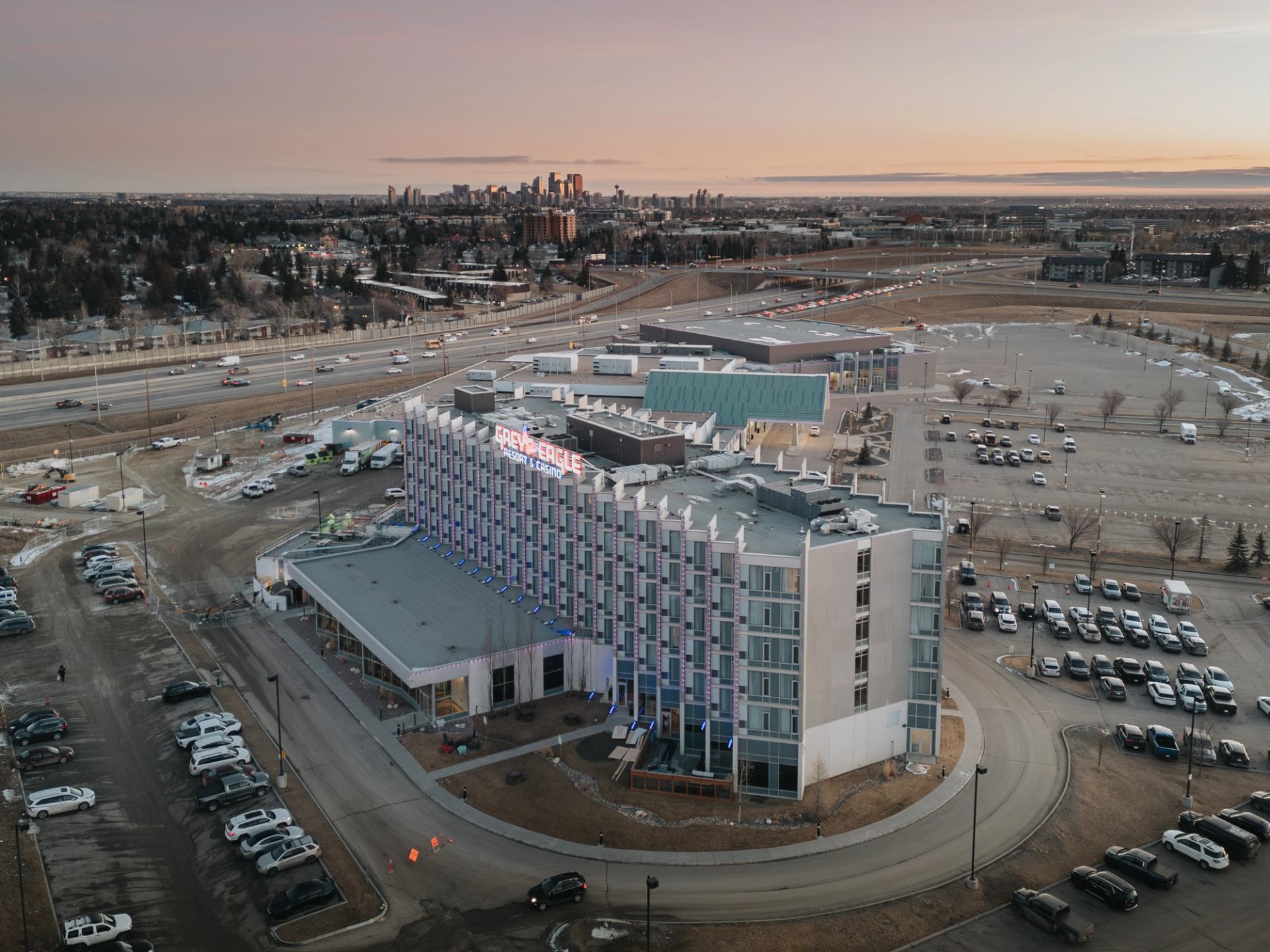 Aerial view of Grey Eagle Resort and Casino with surrounding parking lots and highway.