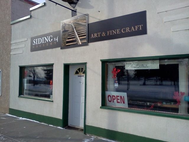 Siding 14 Gallery storefront with Art & Fine Craft sign and OPEN window sign.