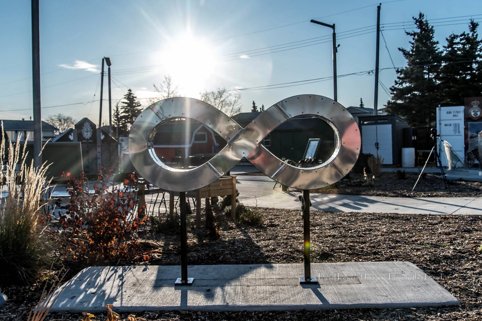 Metal infinity sculpture lit by the sun in the memorial garden