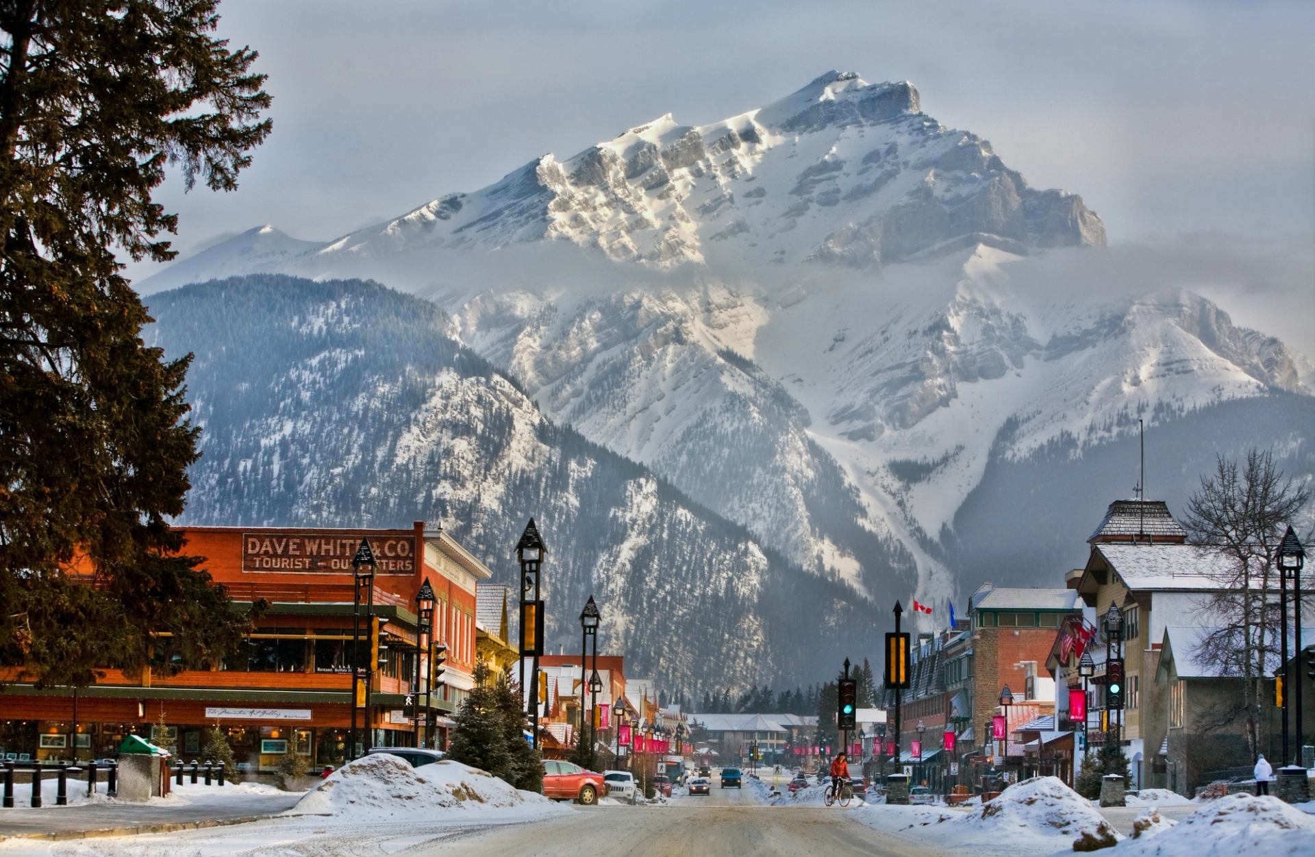 Snowy mountain view over a charming town street.