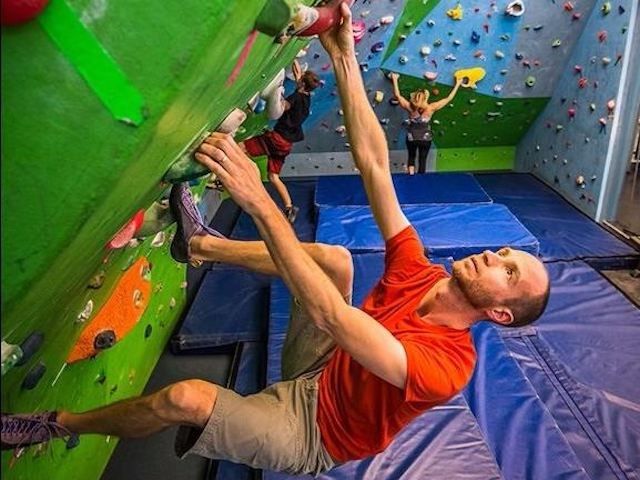 A man climbing the bouldering wall