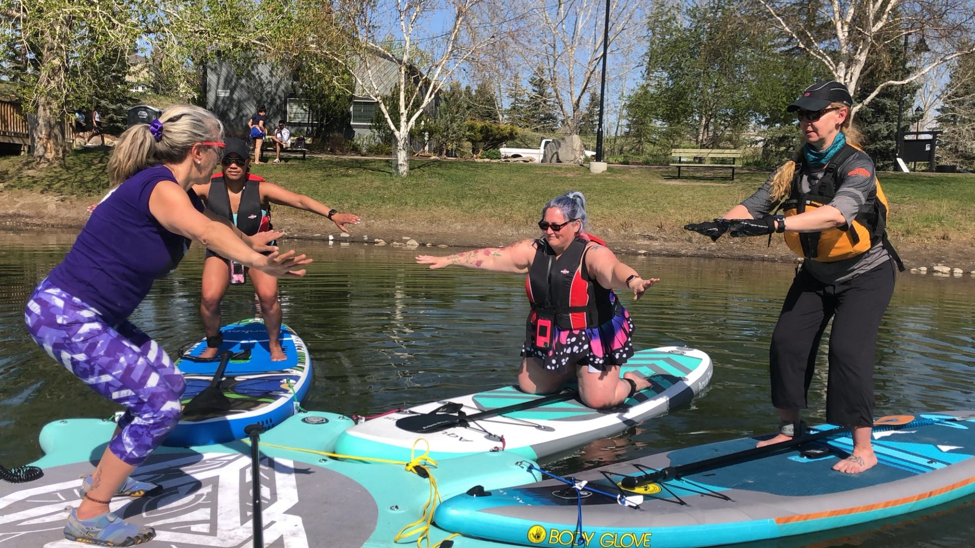 People on paddleboards in a lake.