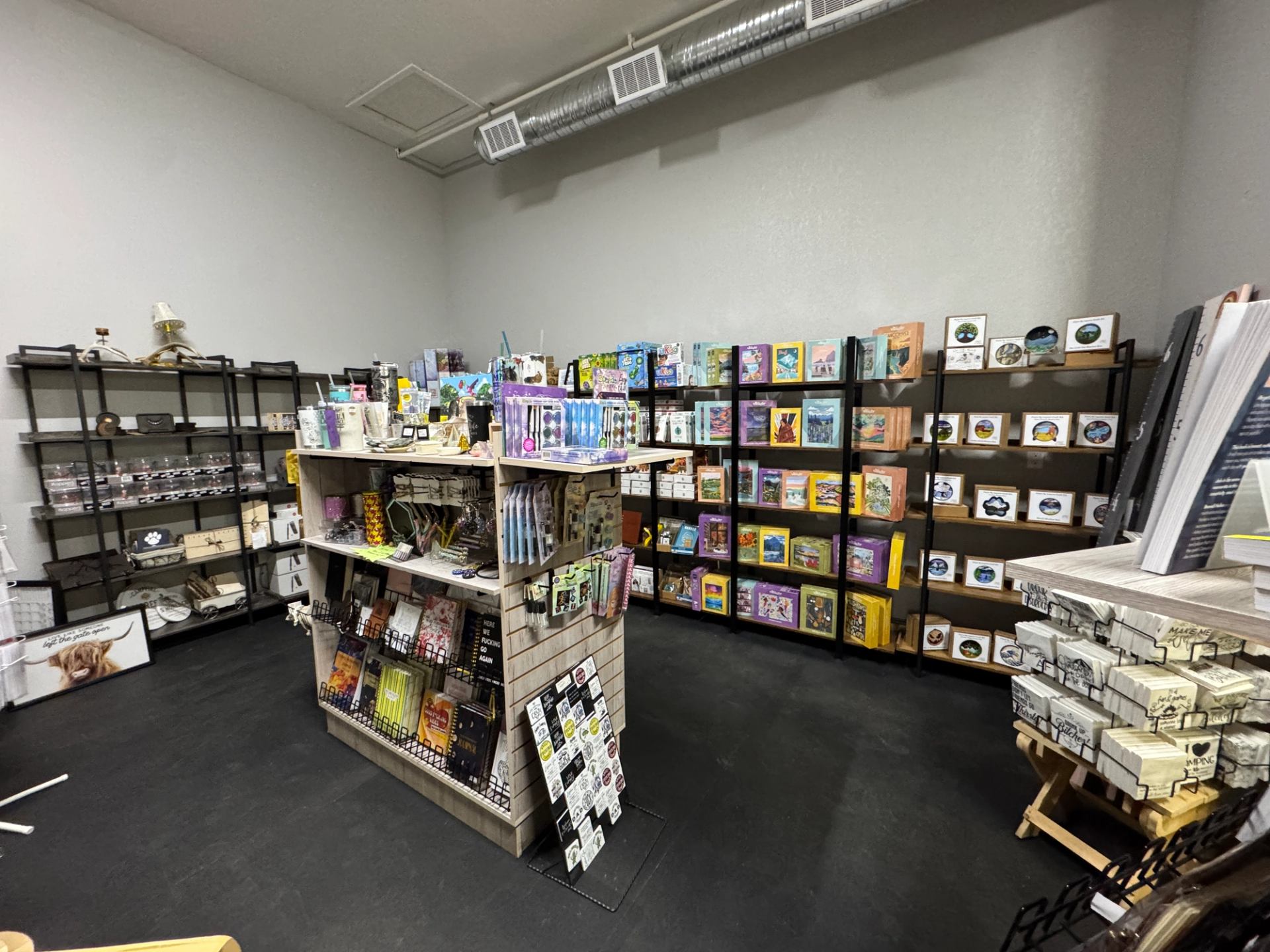 Colorful books and goods neatly arranged on store shelves.