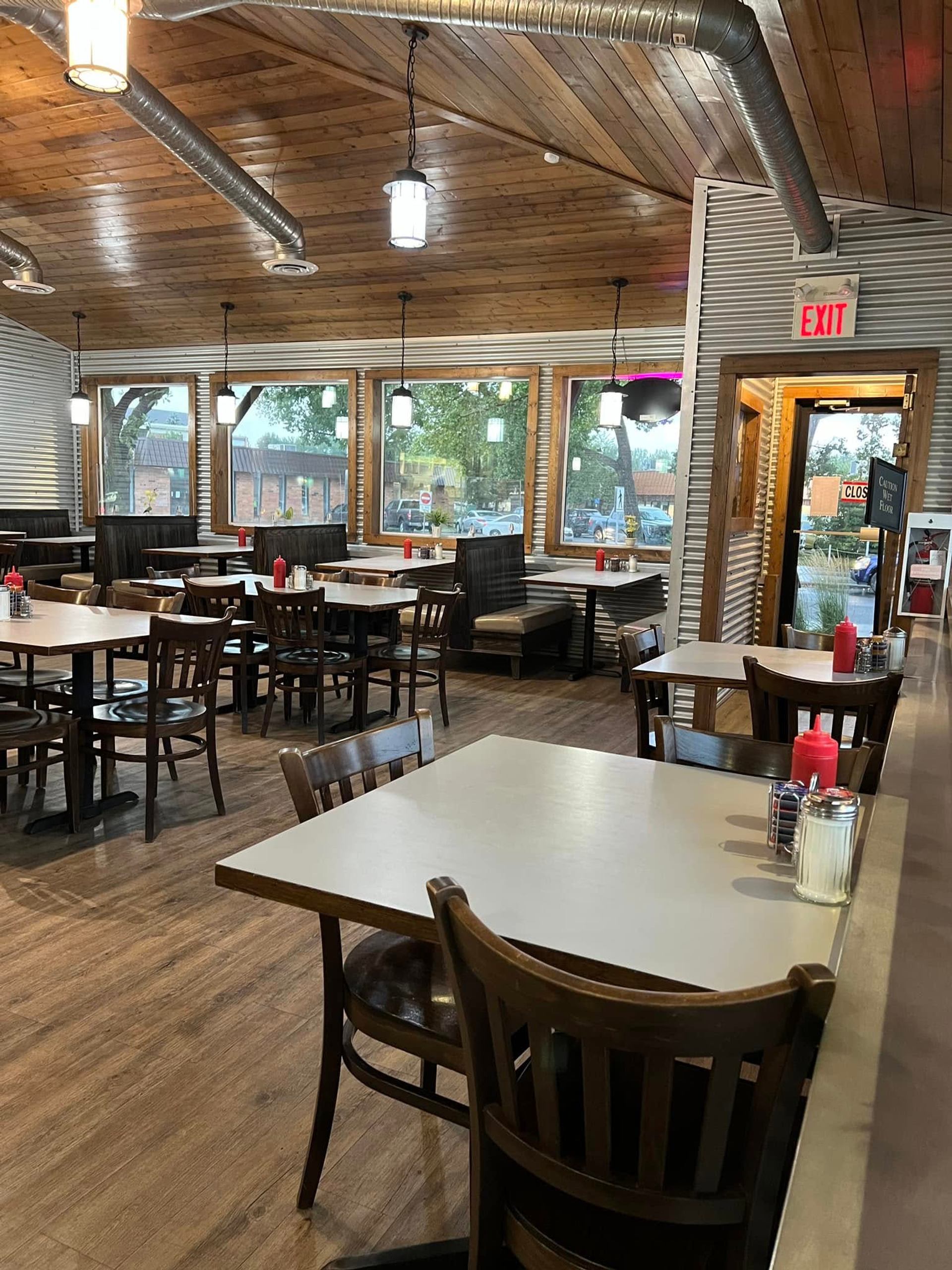 Dining area at Southfork Restaurant with wooden tables and big windows