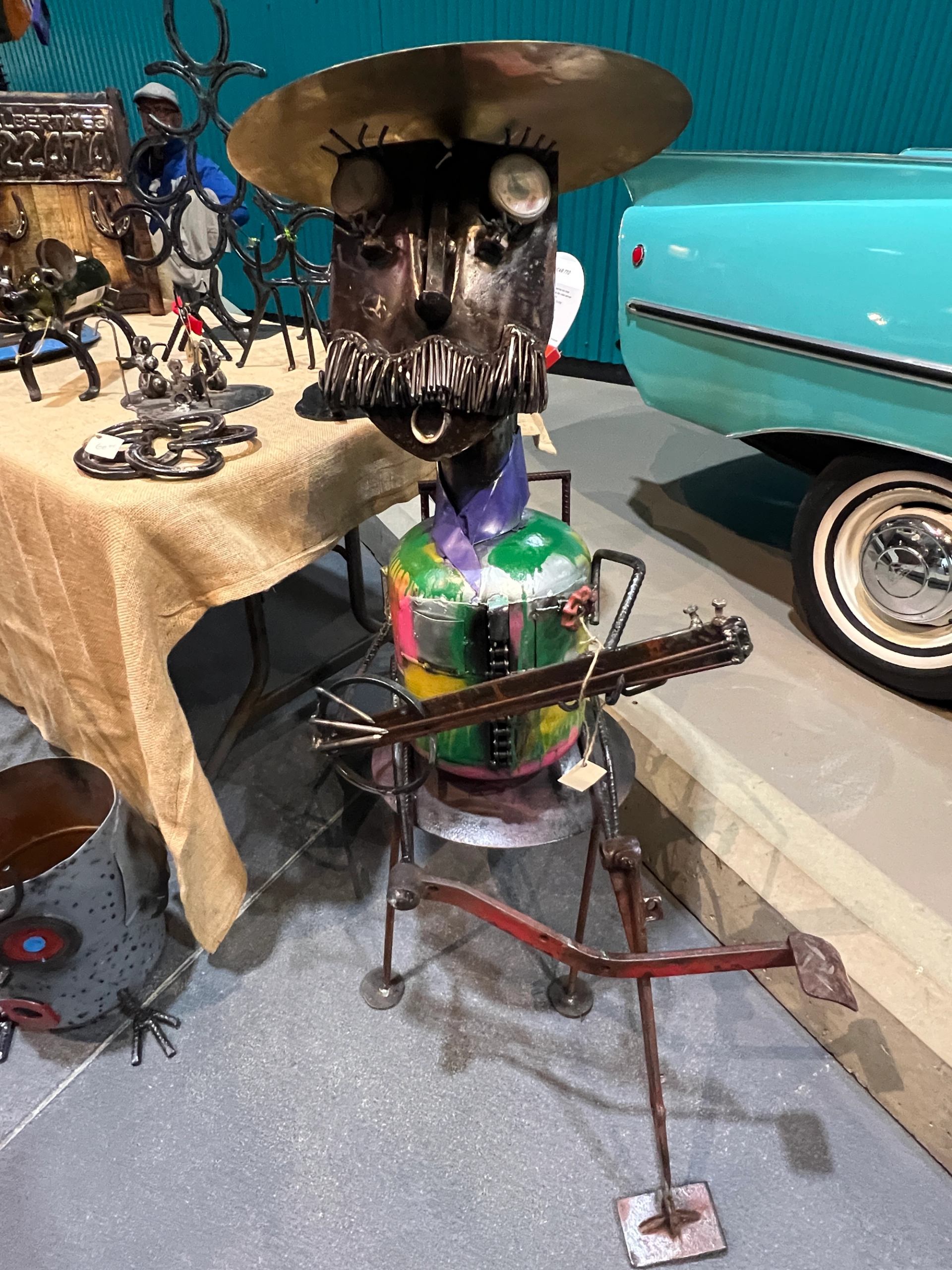 Colorful metal sculpture shaped like a musician holding a guitar.