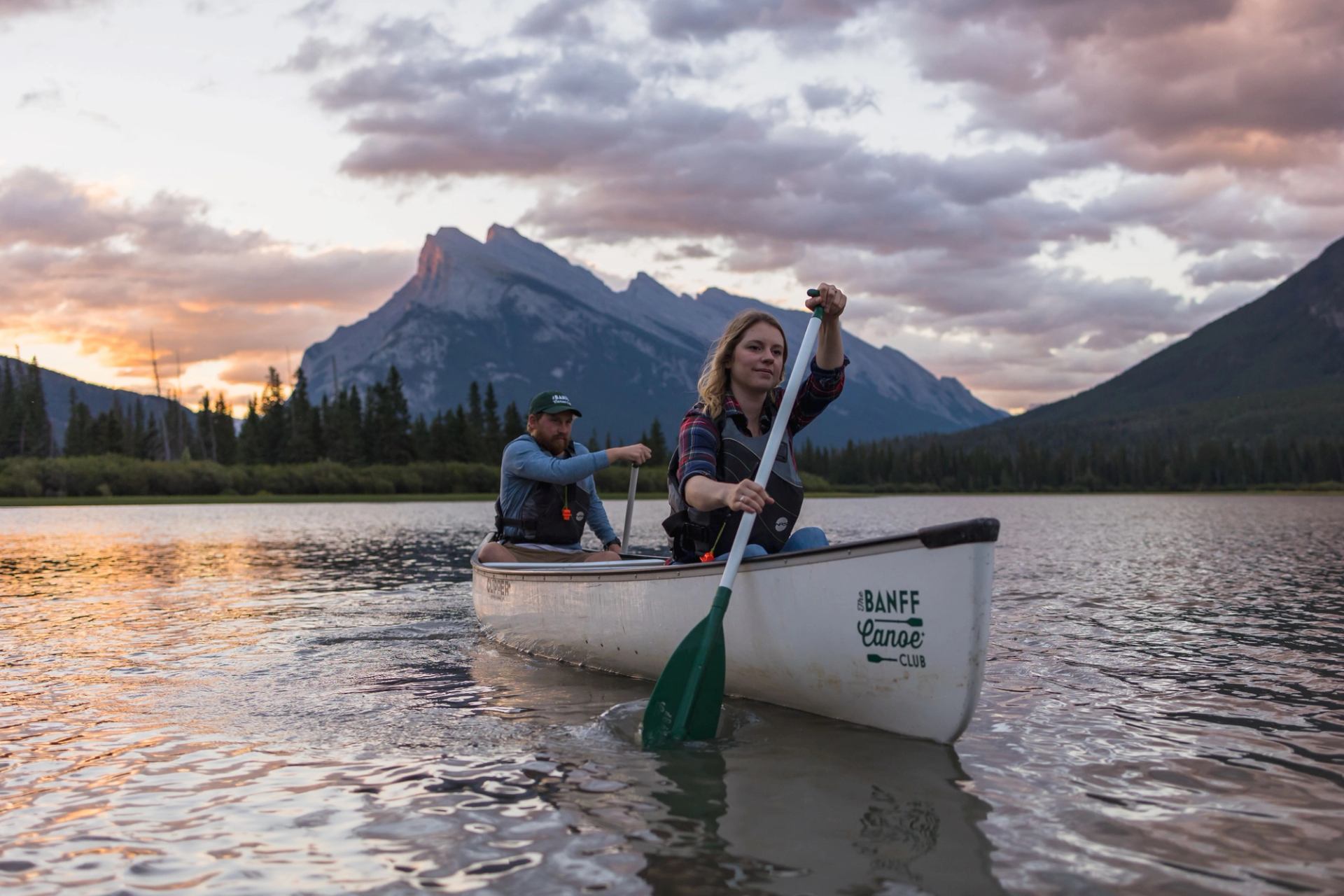 A man and women rowing a canoe