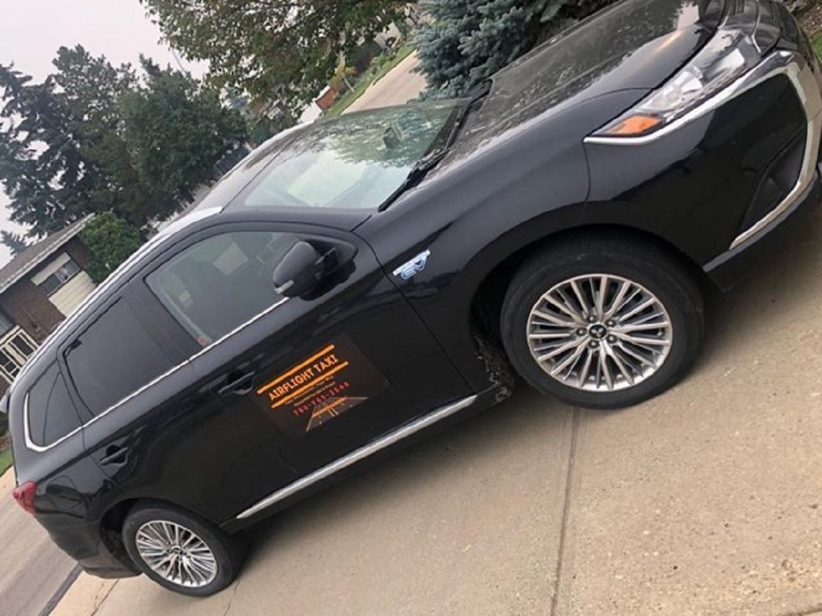 Black SUV with the company logo on the side.