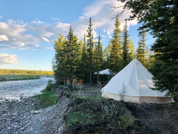 Glamping tent set up by the river.