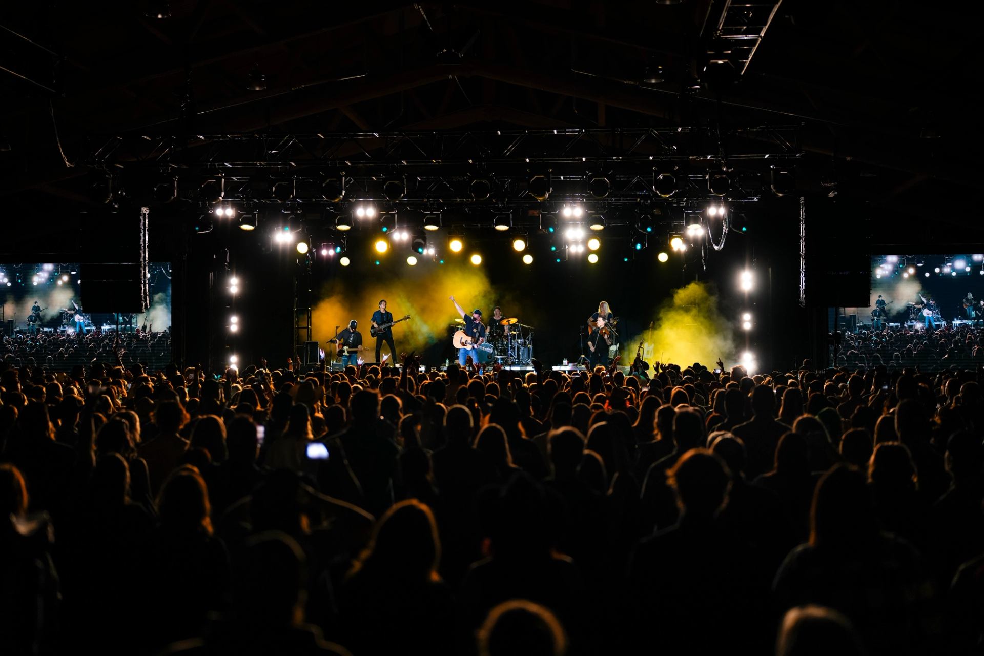 Concert crowd enjoying live music and lights at Spruce Meadows.