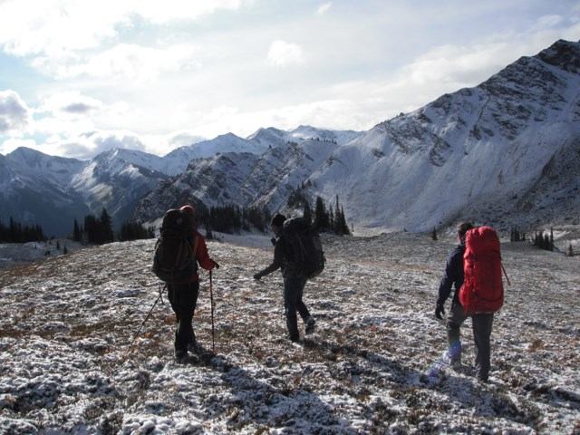 Three people backpacking in the winter.
