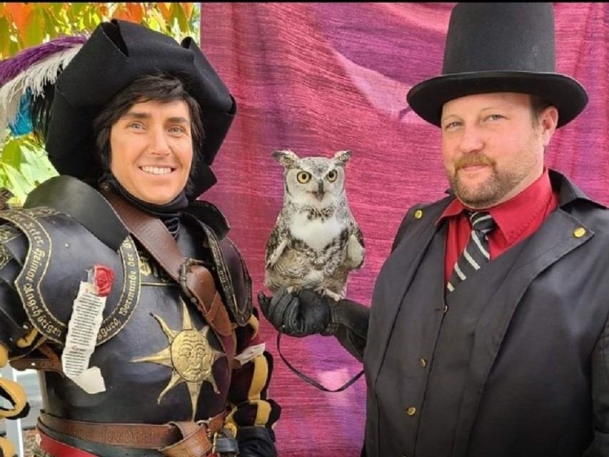 wo costumed performers pose with sword and owl.