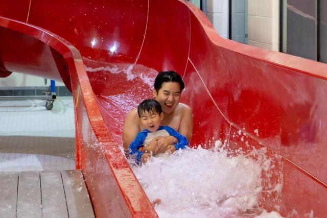 Father and son on waterslide at Terwillegar Community Recreation Centre.